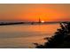 Scenic waterfront view with a sailboat on the horizon and a tranquil sunset at 612 Shore Rd, Nokomis, FL 34275