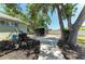 Backyard featuring a paved area, mature trees, and a fenced boundary for privacy at 7420 Tuttle Ave, Sarasota, FL 34243