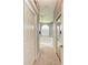 Hallway view of a spacious bathroom featuring tile floors, large tub, and a walk-in shower at 7420 Tuttle Ave, Sarasota, FL 34243