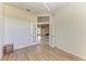 Bright room with wood flooring leading to a dining room through glass double doors at 7420 Tuttle Ave, Sarasota, FL 34243