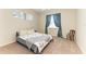 Bedroom with carpet flooring, a window with curtains, and a neatly made bed at 7420 Tuttle Ave, Sarasota, FL 34243