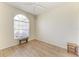 Cozy room featuring wood floors, a window with blinds and a small wooden bench at 7420 Tuttle Ave, Sarasota, FL 34243