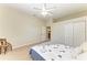 Well-lit bedroom with carpet, a ceiling fan, a closet and a comfortable looking bed at 7420 Tuttle Ave, Sarasota, FL 34243