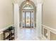Elegant foyer features arched entry, decorative door with sidelights, and tiled flooring, creating a welcoming entrance at 7420 Tuttle Ave, Sarasota, FL 34243
