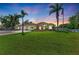 Charming home featuring a well-manicured lawn, palm trees, and a stately American flag at 7420 Tuttle Ave, Sarasota, FL 34243