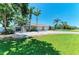 Beautifully landscaped front yard with mature palm trees framing the home's facade at 7420 Tuttle Ave, Sarasota, FL 34243