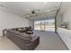 Finished garage boasts recessed lighting, sectional sofa, and built in storage cabinets at 7420 Tuttle Ave, Sarasota, FL 34243