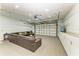 Finished garage boasts recessed lighting, sectional sofa and built in storage cabinets at 7420 Tuttle Ave, Sarasota, FL 34243