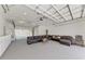 Finished garage boasts recessed lighting, sectional sofa, and built in storage cabinets at 7420 Tuttle Ave, Sarasota, FL 34243