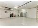 Garage with epoxy flooring, utility sink, refrigerator, and door to the house at 7420 Tuttle Ave, Sarasota, FL 34243