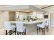 Gourmet kitchen features granite countertops, stainless appliances, a bar area with stools for modern living at 7420 Tuttle Ave, Sarasota, FL 34243