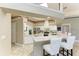 Bright, open kitchen with granite counters, white cabinetry, stainless appliances, and bar seating, great for entertaining at 7420 Tuttle Ave, Sarasota, FL 34243