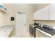 Functional laundry room equipped with sleek, modern appliances and ample counter space at 7420 Tuttle Ave, Sarasota, FL 34243
