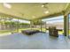 Enclosed patio area with spa and outdoor grill, creating an inviting space for relaxation and entertainment at 7420 Tuttle Ave, Sarasota, FL 34243