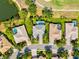 Bird's eye view of houses with sparkling pools, complemented by green lawns and tree-lined streets in a lovely area at 7582 Camden Harbour Dr, Bradenton, FL 34212