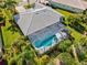 Aerial view of a beautiful home showcasing the screened pool area, well-maintained landscaping, and backyard at 7582 Camden Harbour Dr, Bradenton, FL 34212