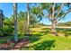 Serene backyard view showcasing lush greenery and mature trees overlooking the golf course at 7582 Camden Harbour Dr, Bradenton, FL 34212