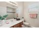 Clean bathroom features a white vanity, large mirror, and a shower with decorative tile accents at 7582 Camden Harbour Dr, Bradenton, FL 34212