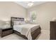 Cozy bedroom featuring a comfortable bed, neutral decor, and a window bringing in natural light at 7582 Camden Harbour Dr, Bradenton, FL 34212