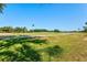 Expansive golf course view with manicured greens and mature trees under a clear blue sky at 7582 Camden Harbour Dr, Bradenton, FL 34212