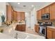 Well-equipped kitchen with stainless steel appliances, wood cabinets, and tile backsplash at 7582 Camden Harbour Dr, Bradenton, FL 34212