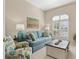Relaxing living room with stylish furniture, a bright window, and tasteful coastal decor accents at 7582 Camden Harbour Dr, Bradenton, FL 34212