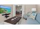 Open living room with a wall-mounted TV, comfortable seating, and seamless flow to other living spaces at 7582 Camden Harbour Dr, Bradenton, FL 34212