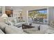 Open living room with comfortable seating, neutral colors, and sliding glass doors leading to outdoor patio at 7582 Camden Harbour Dr, Bradenton, FL 34212