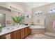 Luxurious bathroom with double vanity, soaking tub, and a separate glass-enclosed shower at 7582 Camden Harbour Dr, Bradenton, FL 34212