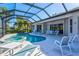 Screened in pool and spa with ample patio seating, offering a relaxing outdoor living space at 7582 Camden Harbour Dr, Bradenton, FL 34212