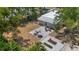 Aerial view of backyard featuring patio with seating and gardening beds, with mature trees surrounding at 815 Hand Ave, Sarasota, FL 34232