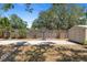 Backyard featuring a basketball hoop, and storage shed, perfect for outdoor activities at 815 Hand Ave, Sarasota, FL 34232