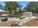 Landscaped backyard featuring a gardening area with white gravel and metal garden beds at 815 Hand Ave, Sarasota, FL 34232
