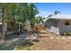 Property featuring a spacious backyard with partial wooden fence, landscaping, and mature trees at 815 Hand Ave, Sarasota, FL 34232