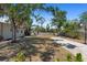 Spacious backyard featuring mature trees and a basketball court, offering a serene setting at 815 Hand Ave, Sarasota, FL 34232