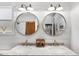 Bright and modern bathroom featuring a double vanity, marble countertop, and decorative shiplap walls at 815 Hand Ave, Sarasota, FL 34232