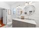 Bright bathroom with a gray double vanity, marble countertop, stylish mirrors, and shiplap walls at 815 Hand Ave, Sarasota, FL 34232