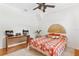 Bright bedroom with a wooden bed frame, ceiling fan and decorative headboard at 815 Hand Ave, Sarasota, FL 34232
