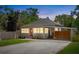 Dusk view of charming single Gathering home with a metal roof, carport and fenced yard at 815 Hand Ave, Sarasota, FL 34232
