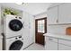 Laundry room features stacked washer and dryer, tile floors and ample storage space at 815 Hand Ave, Sarasota, FL 34232