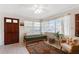 Cozy living room with tiled floors, a futon, and ample natural light from large windows at 815 Hand Ave, Sarasota, FL 34232