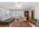 The sun-filled living room features tiled floors, a comfortable futon, and a stylish area rug at 815 Hand Ave, Sarasota, FL 34232