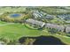 Gorgeous aerial view of the condo complex with a golf course and pond nearby at 9470 High Gate Dr # 2213, Sarasota, FL 34238