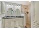 Elegant bathroom features a double vanity with granite countertops and a glass-enclosed shower at 9470 High Gate Dr # 2213, Sarasota, FL 34238
