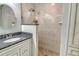 Bathroom showcasing a stylish vanity with granite countertops and a tiled walk-in shower at 9470 High Gate Dr # 2213, Sarasota, FL 34238