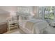 Inviting bedroom with shuttered windows, a comfortable bed, and stylish decor for a peaceful retreat at 9470 High Gate Dr # 2213, Sarasota, FL 34238