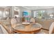 Cozy dining area featuring a round table, stylish decor, and an open view to the living space and outside at 9470 High Gate Dr # 2213, Sarasota, FL 34238