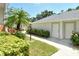 Charming exterior view with lush landscaping, a walkway, and a private entrance at 9470 High Gate Dr # 2213, Sarasota, FL 34238