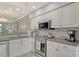 Kitchen with granite countertops, stainless steel appliances, and ample storage space at 9470 High Gate Dr # 2213, Sarasota, FL 34238