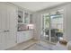 Kitchen with glass front cabinets, granite countertops, and access to a covered patio at 9470 High Gate Dr # 2213, Sarasota, FL 34238
